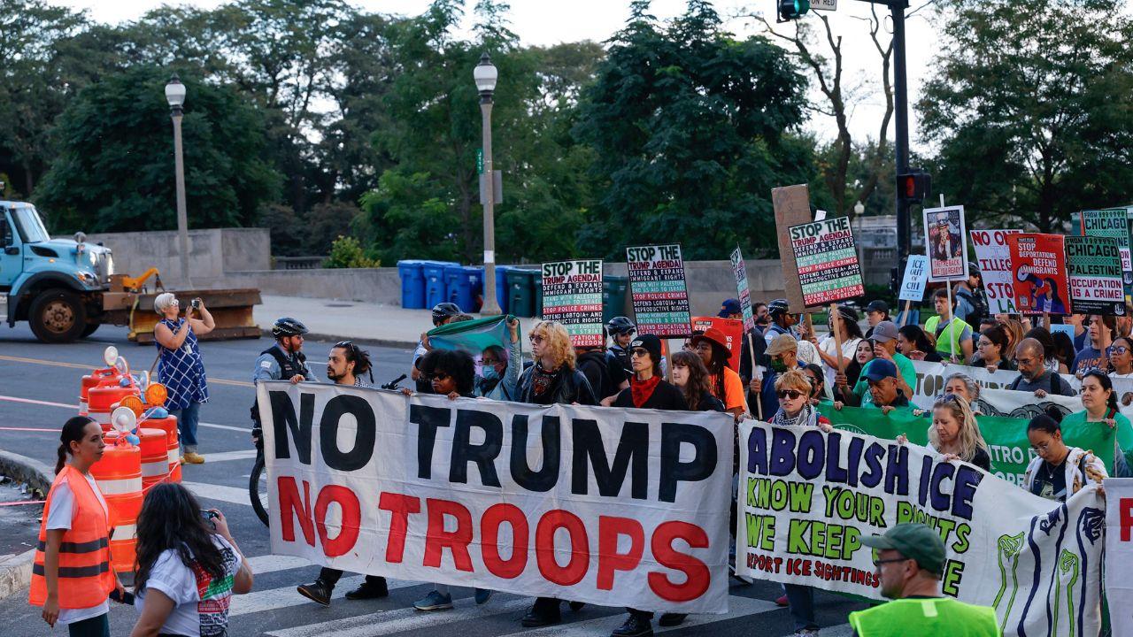 Demonstrators march through downtown during a protest against President Donald Trump's immigration policies